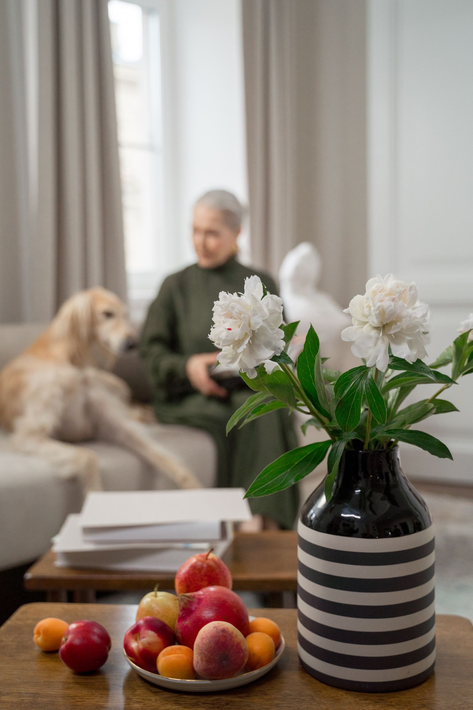 A woman relaxing with her dog in a warm home setting.